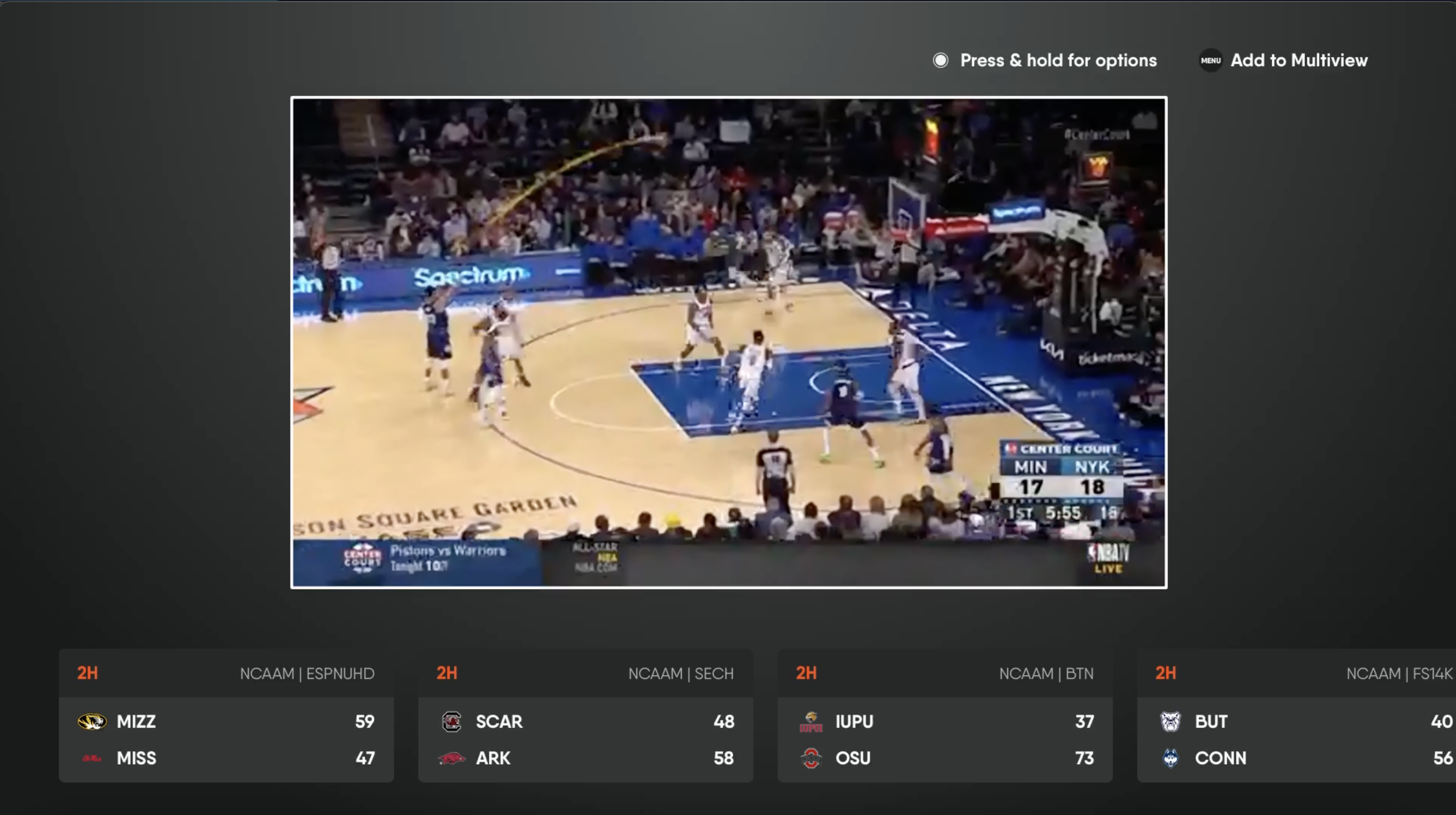 Live video on the FuboTV app for Apple TV with Scoreboard widget enabled; showing scores at the bottom of the screen